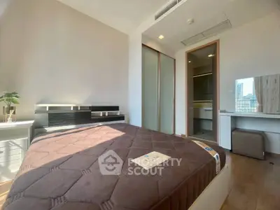 Modern bedroom with large window and stylish furniture in a high-rise apartment.