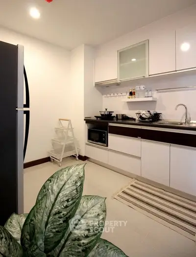Modern kitchen with sleek cabinetry and built-in appliances, perfect for culinary enthusiasts.