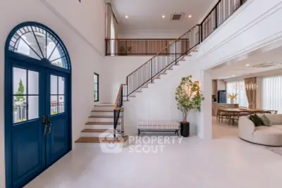 Stunning modern living room with high ceilings and elegant staircase