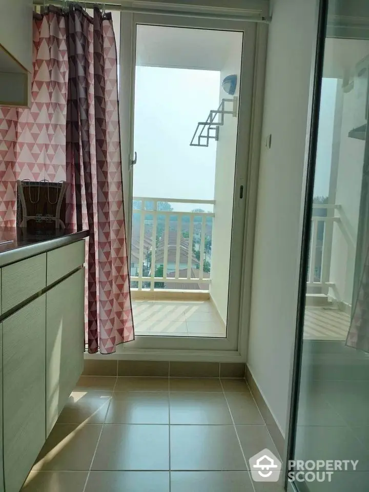 Bright kitchen with balcony access and modern cabinetry