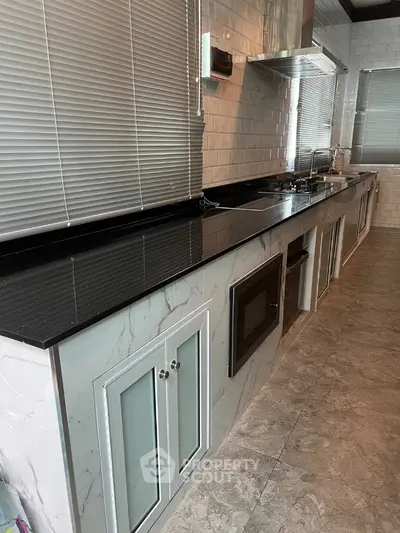 Modern kitchen with sleek black countertop and built-in appliances