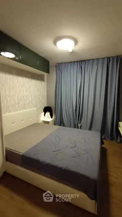 Cozy bedroom with modern decor and soft lighting, featuring a comfortable bed and stylish curtains.