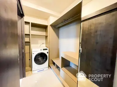 Modern laundry room with Samsung washing machine and ample storage space