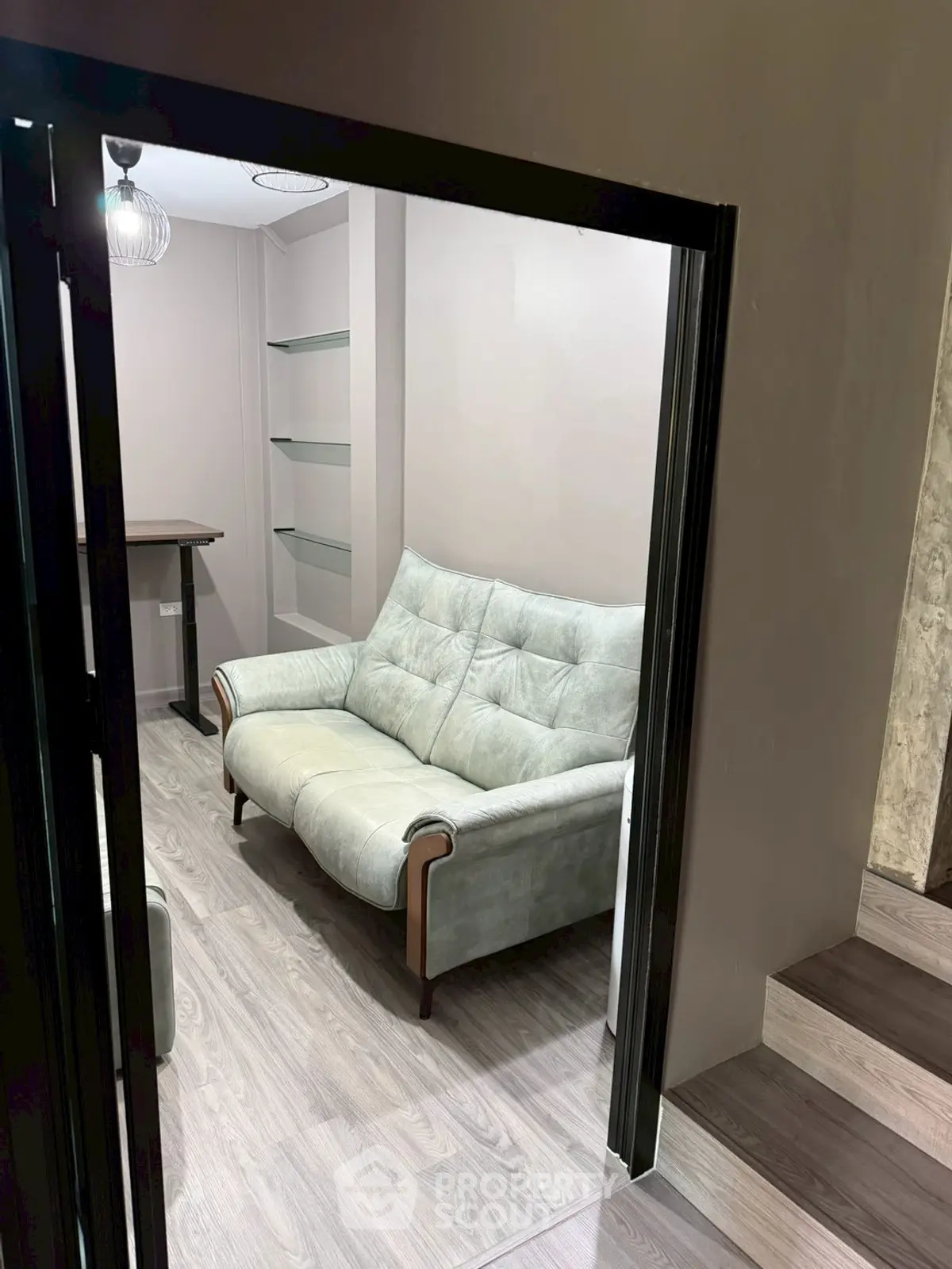 Cozy study room with modern sofa and sleek wooden flooring
