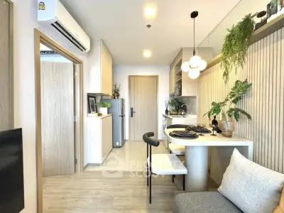 Modern open-layout kitchen and dining area with stylish decor and natural light.