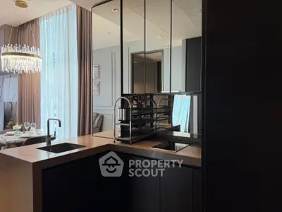 Luxurious modern kitchen with sleek black cabinetry and elegant dining area view.