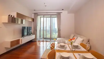 Modern living room with dining area and balcony view in a stylish apartment.