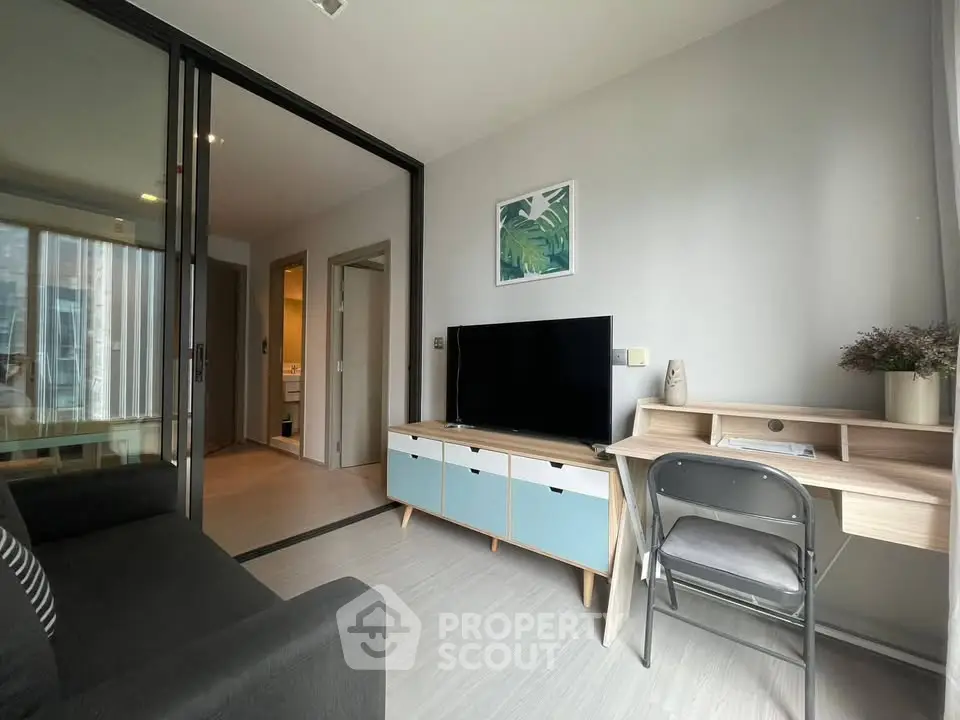 Modern living room with sleek furniture and natural light in a stylish apartment.