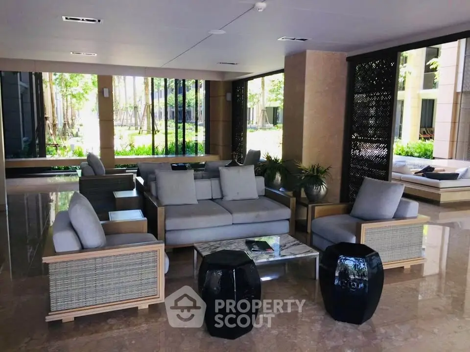 Luxurious lobby with modern seating and garden view, perfect for relaxation and social gatherings.