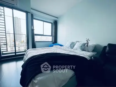 Spacious bedroom with city view and modern decor