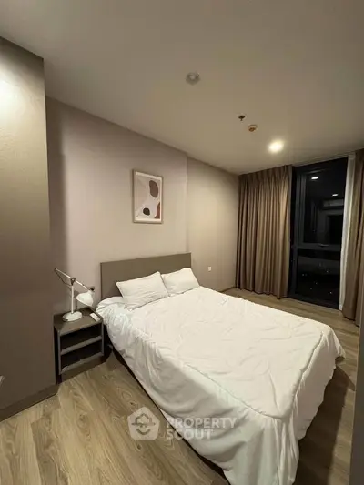 Cozy bedroom with modern decor and soft lighting, perfect for relaxation.