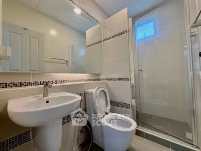 Modern bathroom with sleek fixtures and glass shower enclosure