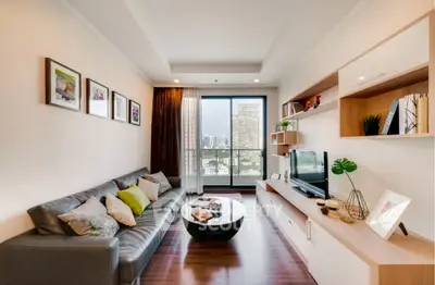 Modern living room with city view, stylish decor, and comfortable seating.