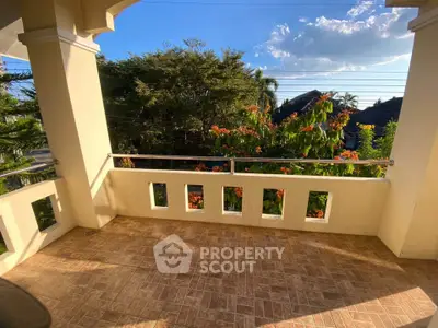 Spacious balcony with scenic garden view and sunny ambiance