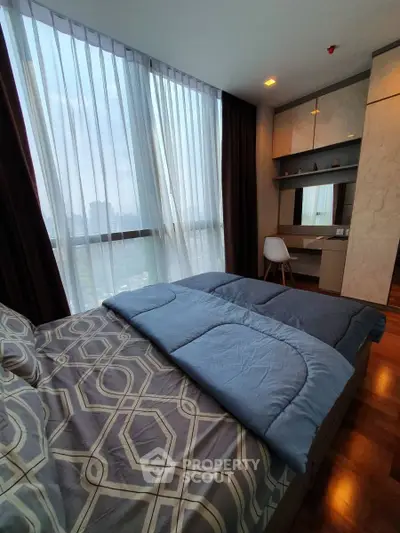Modern bedroom with large windows and stylish decor in a high-rise apartment.