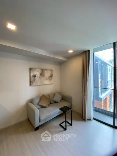 Modern living room with cozy sofa and large window offering city view