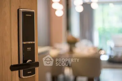 Modern smart lock on wooden door leading to elegant dining area with ambient lighting.