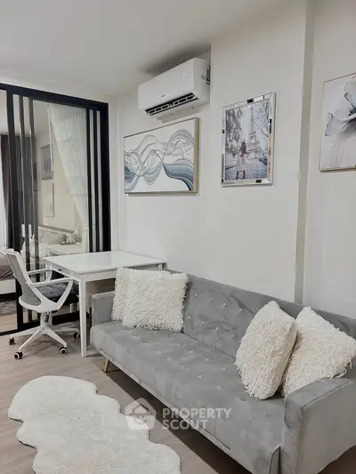 Modern living room with stylish decor and cozy seating in a contemporary apartment.