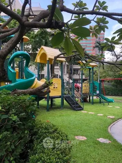 Charming residential playground surrounded by lush greenery, perfect for family-friendly living.