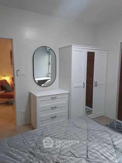 Cozy bedroom with modern white furniture and stylish decor