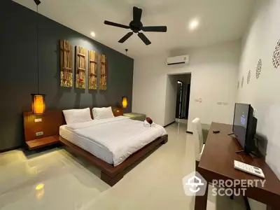 Modern bedroom with stylish decor and ceiling fan in a spacious layout