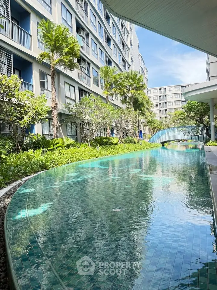 Luxurious condo with stunning pool and lush garden view