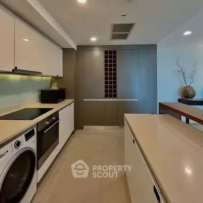 Modern kitchen with sleek appliances and ample storage space