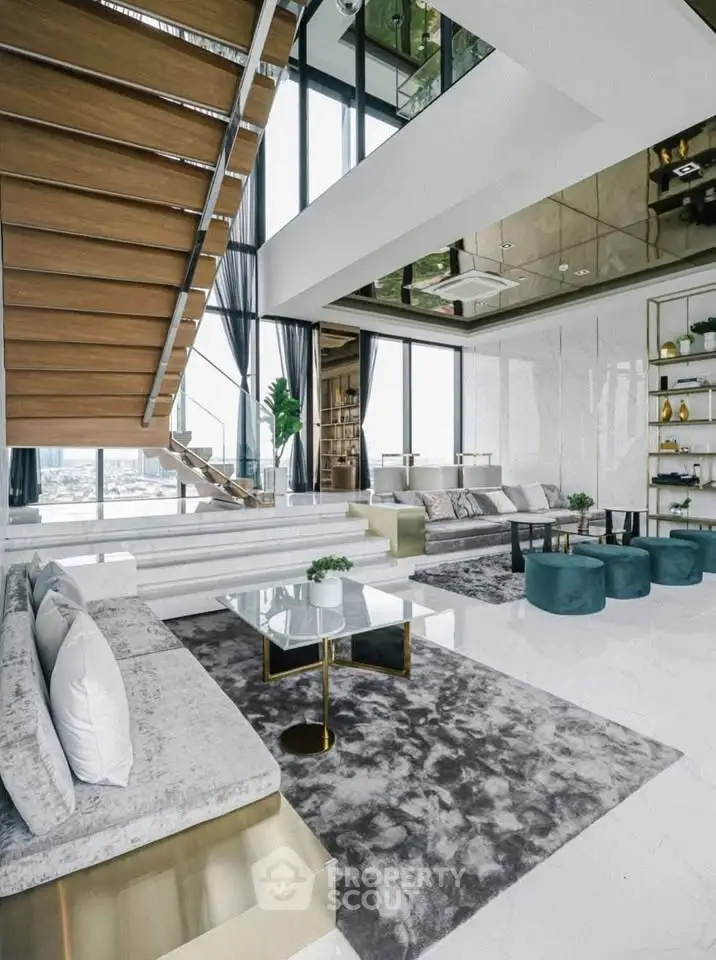 Luxurious modern living room with high ceilings, elegant staircase, and panoramic city views.