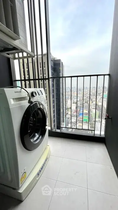 High-rise balcony with city view and washing machine, perfect for urban living.