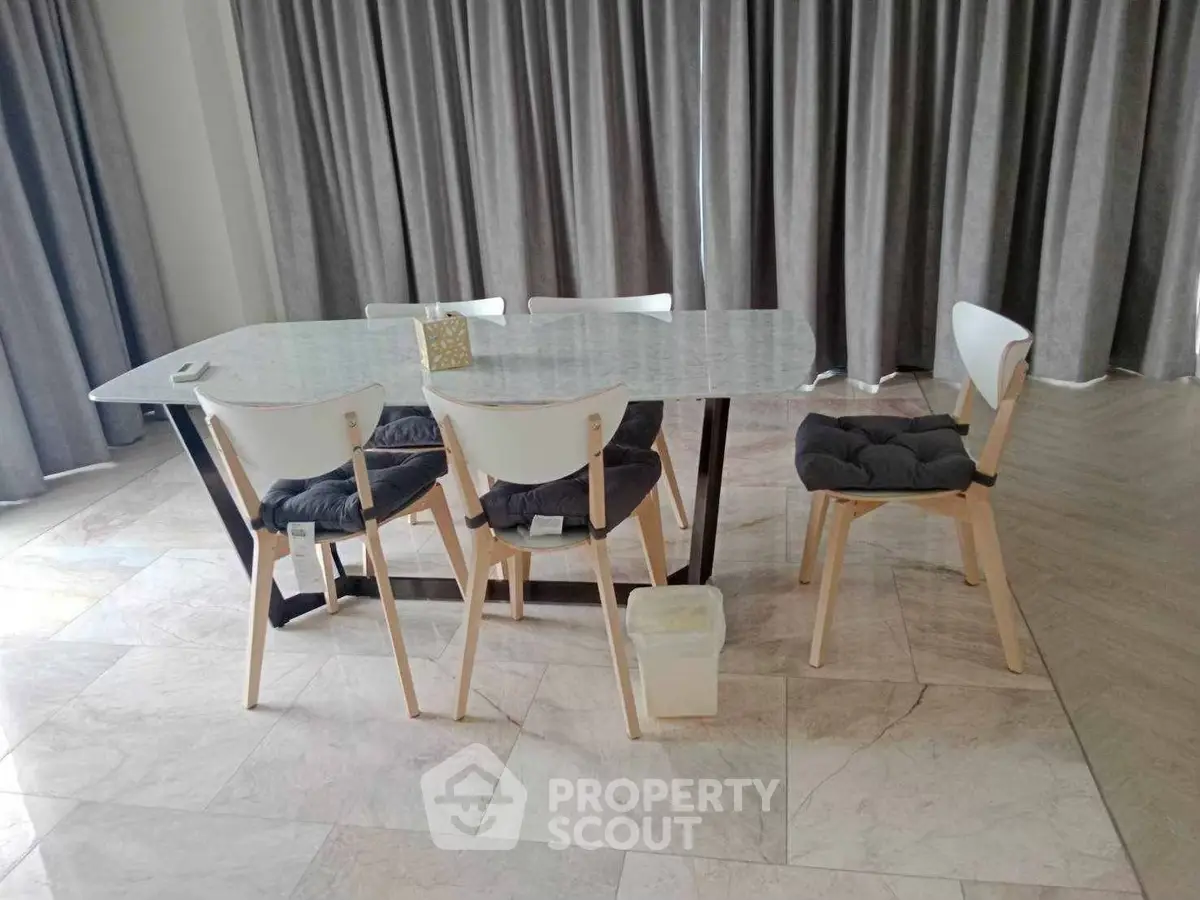 Modern dining area with elegant glass table and stylish chairs