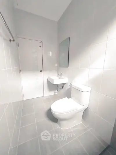 Modern minimalist bathroom with sleek fixtures and bright lighting