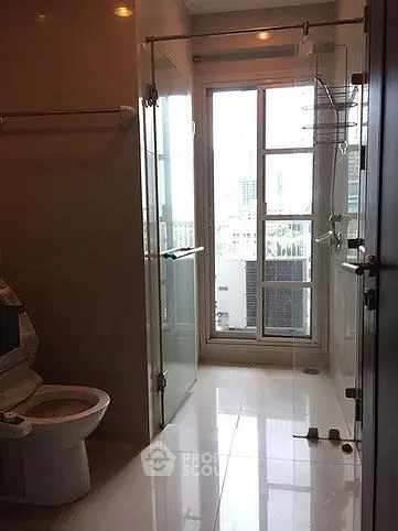 Modern bathroom with glass shower and city view window