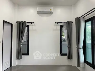 Minimalist room with air conditioning and modern curtains, perfect for a cozy living space.