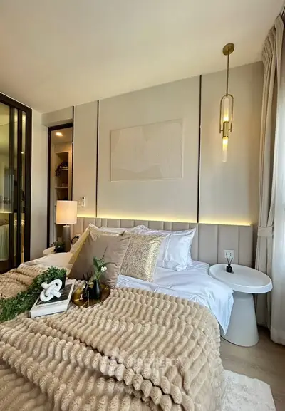Luxurious bedroom with elegant decor and cozy ambiance, featuring plush bedding and stylish lighting.