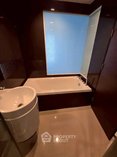 Modern bathroom with sleek bathtub and stylish sink in a contemporary apartment.
