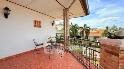Spacious balcony with scenic view and stylish outdoor seating.