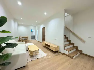 Spacious modern living room with wooden flooring and stylish furniture in a contemporary home.
