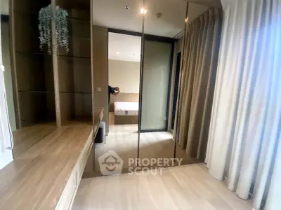 Spacious bedroom with mirrored wardrobe and elegant wooden flooring