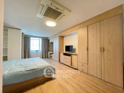 Spacious bedroom with modern wooden furniture and natural light