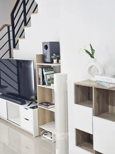 Modern living room with sleek TV stand and stylish shelving unit