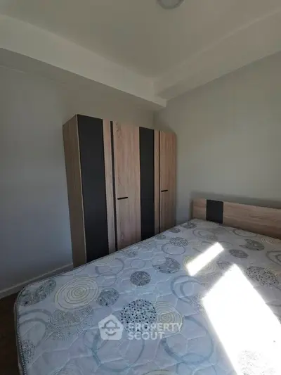 Cozy bedroom with modern wardrobe and stylish bed in bright apartment