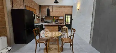 Charming industrial-style kitchen with brick accents and cozy dining area.