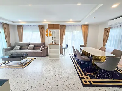 Spacious modern living room with elegant dining area and large windows