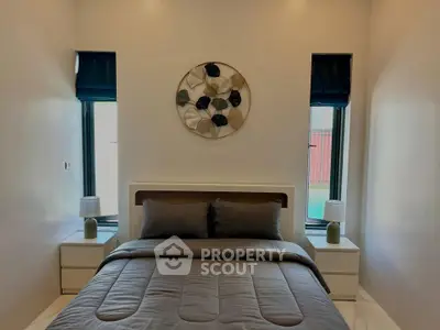 Cozy bedroom with modern decor and natural light, perfect for relaxation.