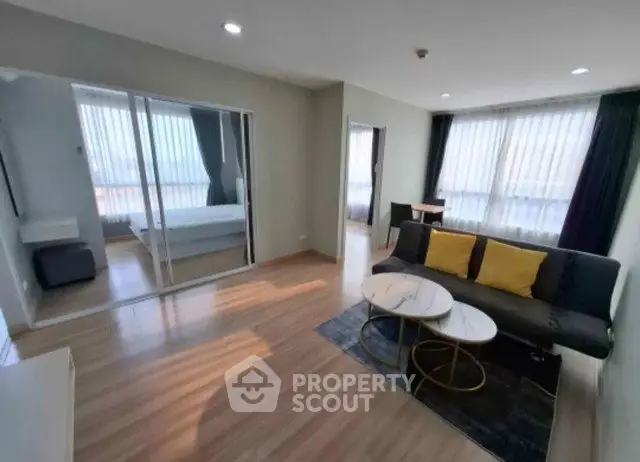 Modern living room with wooden flooring and stylish furniture in a bright apartment.
