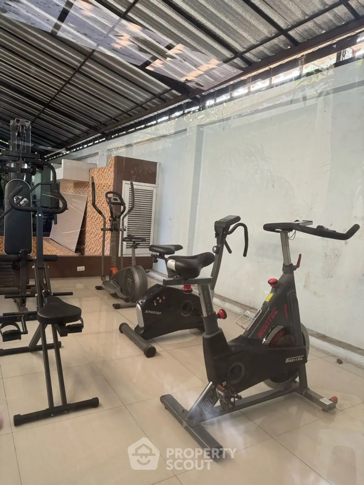 Modern gym with exercise bikes and fitness equipment in a sleek, well-lit space.