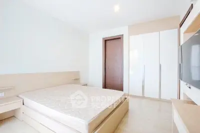 Spacious modern bedroom with minimalist design and ample natural light