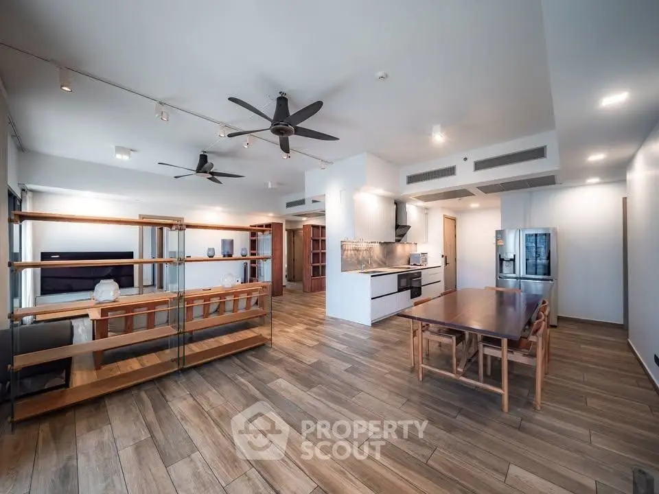 Spacious modern living room with open kitchen and wooden flooring