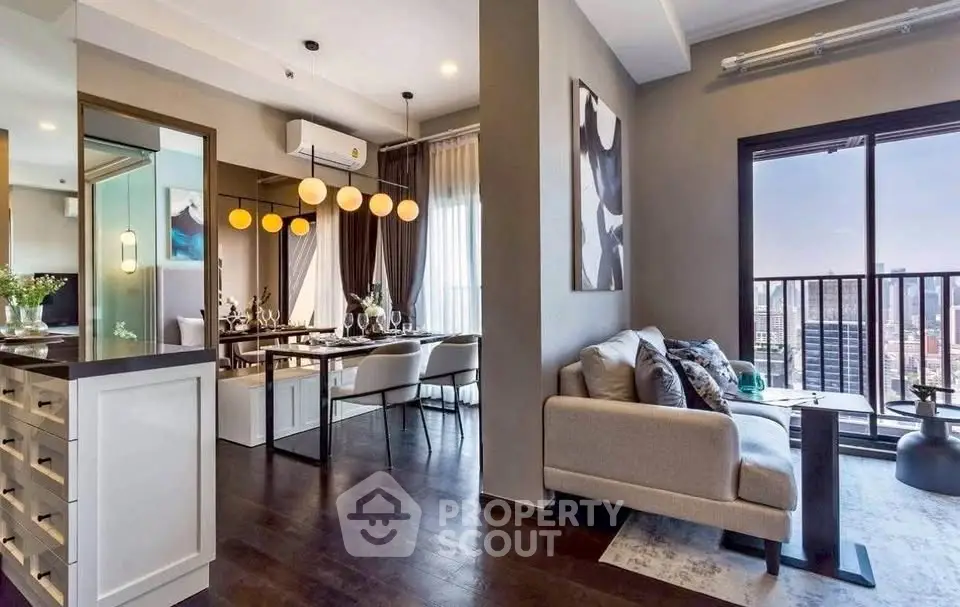 Modern open-plan living and dining area with city view balcony in luxury apartment.
