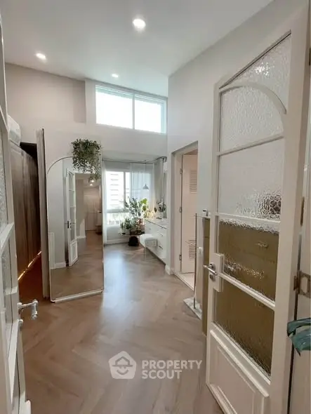 Chic modern interior with elegant wooden flooring and stylish decor, perfect for urban living.